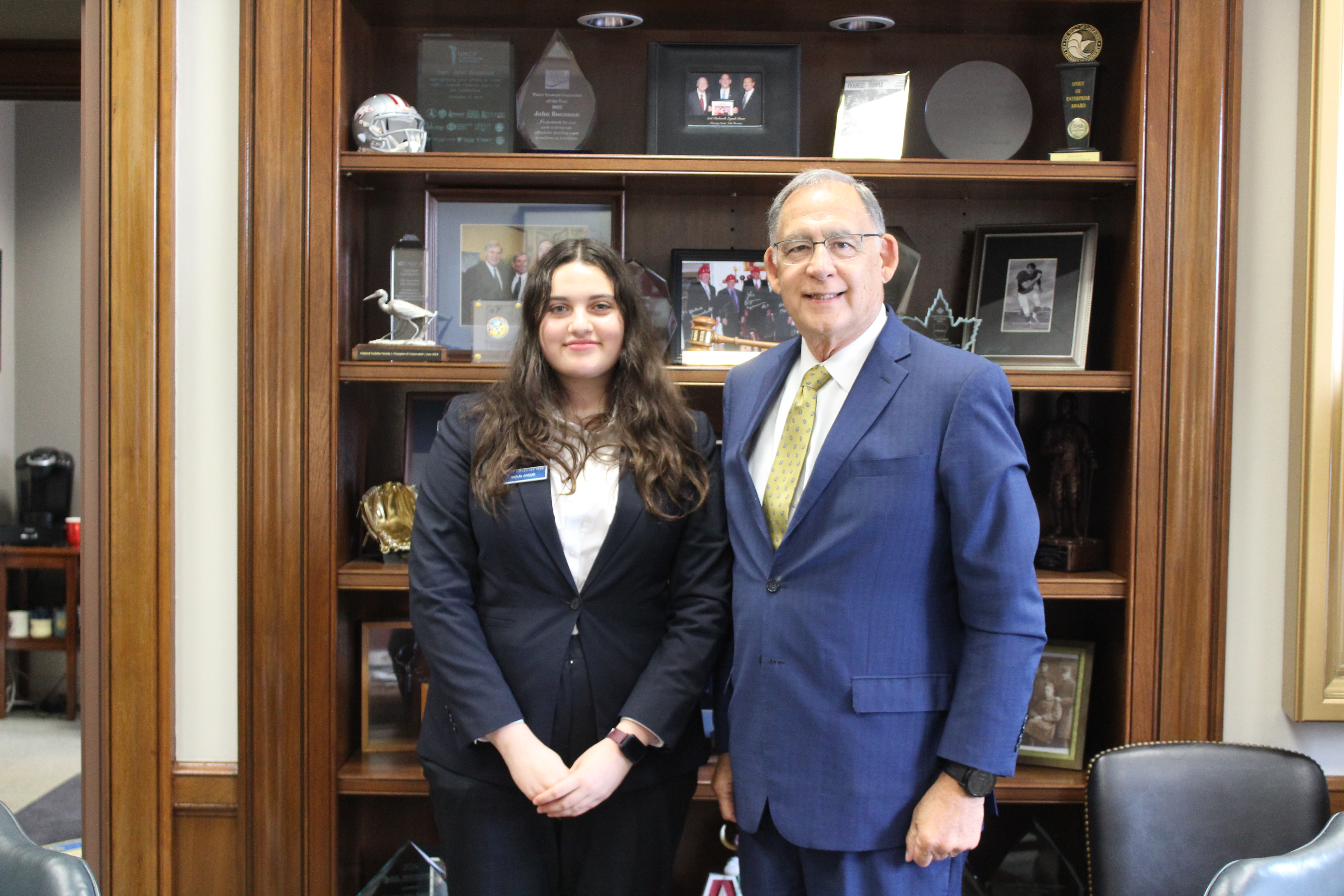 Senate Page Mia Al Ansari stands with Senator John Boozman.